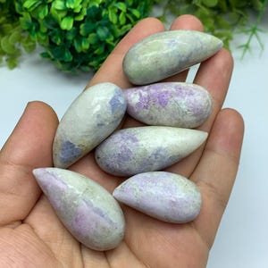 May include: A set of three ceramic mugs with a speckled, matte finish. The mugs are in shades of cream, light gray, and dark gray. Each mug has a simple, minimalist design and a rounded handle.