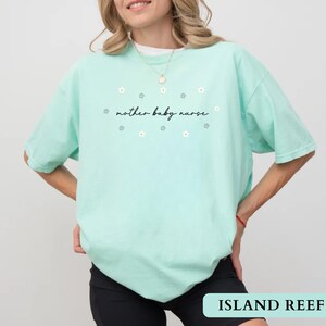 Mint green island reef cute NICU nurse gift t-shirt worn by a model showcasing the daisy graphic.