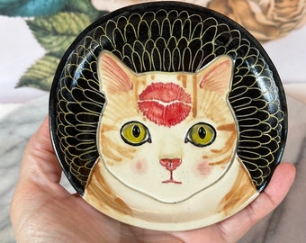 Kiss your cat ceramic plate - green eyed ginger tabby cat with red lip mark on forehead - black sgraffito background - prep dish, ring dish