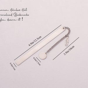 May include: A silver bookmark with a chain and a round charm. The bookmark is 4.9 inches long and 0.6 inches wide. The chain is 3.9 inches long. The text on the bookmark reads "Premium stainless steel -Personalized Bookmarks You deserve it!"
