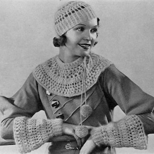 May include: A woman wearing a crocheted hat, collar, and cuffs. The hat, collar, and cuffs are all white and have a lacy design. The woman is wearing a dark dress.