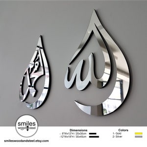 May include: Two mirrored metal wall decor pieces in the shape of a teardrop with the Arabic word for God, "Allah", written inside. The larger piece is 12 inches wide by 18 inches high and the smaller piece is 8 inches wide by 12 inches high. The pieces are available in gold or silver.