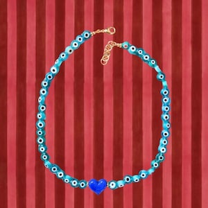 Light blue evil eye necklace with blue heart pendant