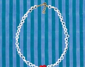 White evil eye necklace with red heart pendant