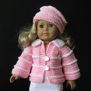 May include: A pink knitted jacket with white stripes and buttons, worn by a doll with blonde hair and a pink and white striped hat.