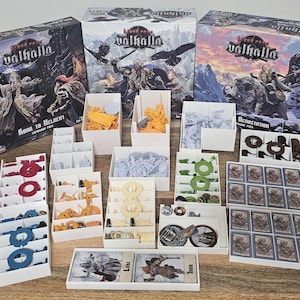 May include: Blood Rage Valhalla board game set including three large game boxes, multiple white plastic organizers, various colored miniature figures, circular tokens, and rectangular game cards featuring illustrations of warriors and mythical creatures.