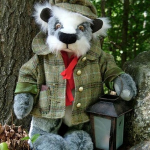 May include: A grey and white stuffed animal wearing a tweed jacket and cap, holding a lantern. The animal has a black nose and large black eyes. The lantern is made of metal and has a glass window.