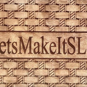 May include: A wooden cutting board with a woven pattern and the text "LetsMakeItSLT" engraved on it.