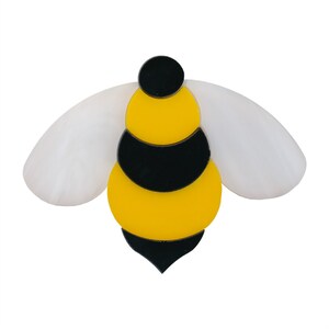May include: A yellow and black bee brooch with white wings. The bee is made of acrylic and has a simple, cartoon-like design.