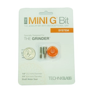 May include: A packaging for a jewelry bit with the text "MINI G Bit" and "THE JEWELRY BIT WITH AN EXCEPTIONAL GRIT" on the front. The packaging also includes the text "SYSTEM" and "Specially Designed For THE GRINDER". The packaging shows a close-up of the bit, a water seal, and a quarter for size comparison.