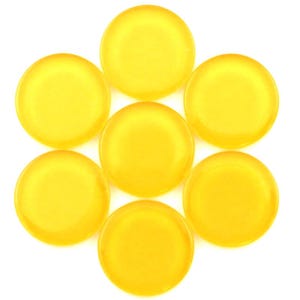 May include: Seven translucent, round, yellow glass cabochons arranged in a flower-like pattern against a white background. Each cabochon has a smooth, domed surface and a vibrant, sunny color.