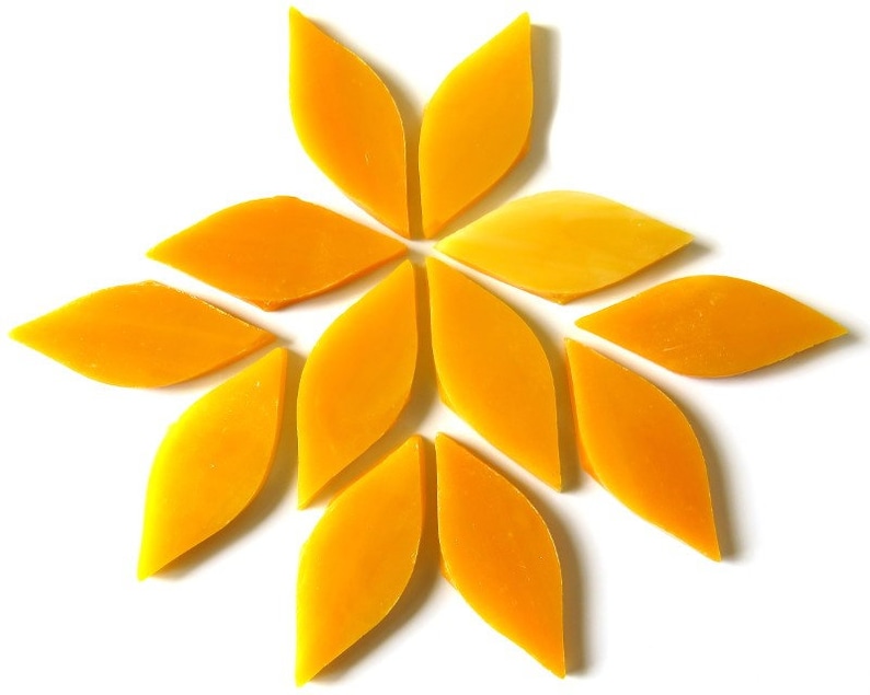 May include: A set of twelve yellow glass mosaic tiles in the shape of a leaf. The tiles are arranged in a starburst pattern.