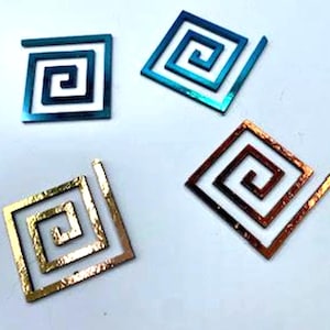 May include: Four decorative metal spirals in different colors. The spirals are in the shape of a square with a spiral design inside. The colors are blue, green, gold, and copper.