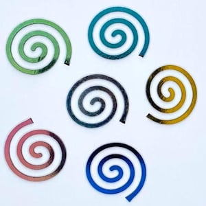 May include: Six iridescent spiral stickers in various colors, including green, blue, gold, black, pink, and teal.