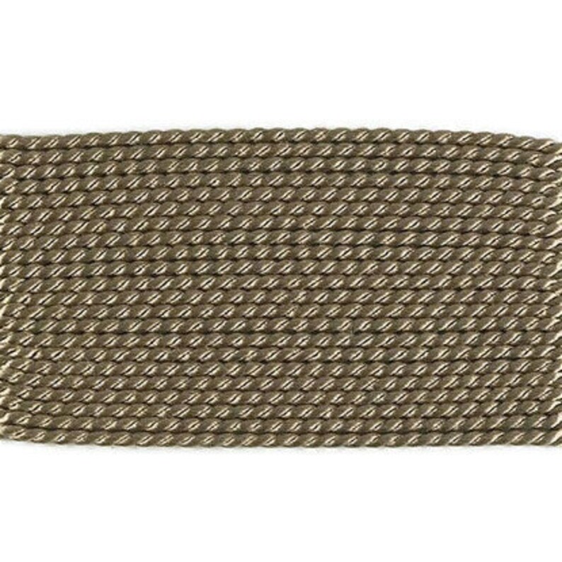 May include: A close-up of a brown braided rope trim. The rope is made of a woven material and has a subtle sheen.