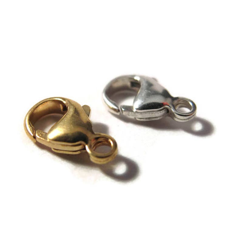 May include: Two lobster claw clasps, one gold and one silver, for jewelry making.