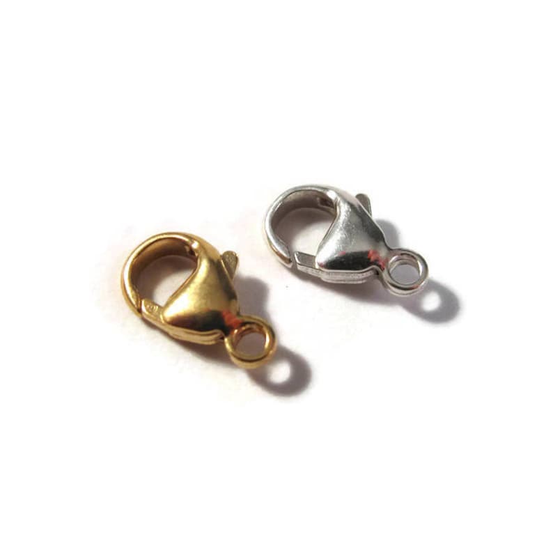May include: Two lobster claw clasps, one gold and one silver, for jewelry making.