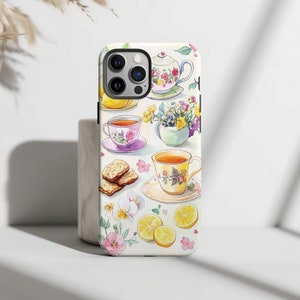 This charming watercolor design features a delightful tea time setting with floral teacups, teapots, lemons, flowers, and biscuits. The soft pastel colors and delicate details create a cozy, inviting scene perfect for any tea lover.