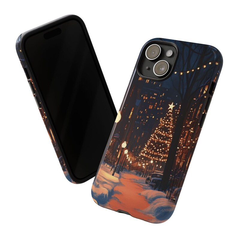 May include: A black phone case featuring a winter scene of a city street with a lit Christmas tree and snow on the ground.