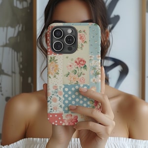 May include: A phone case with a patchwork design featuring floral patterns and a blue and white polka dot pattern. The case is made of a hard plastic material and has a clear back.