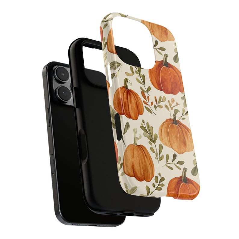 May include: A black phone case with a separate cover featuring a watercolour pattern of orange pumpkins and green leaves on a cream background. The phone case is designed to protect the phone.