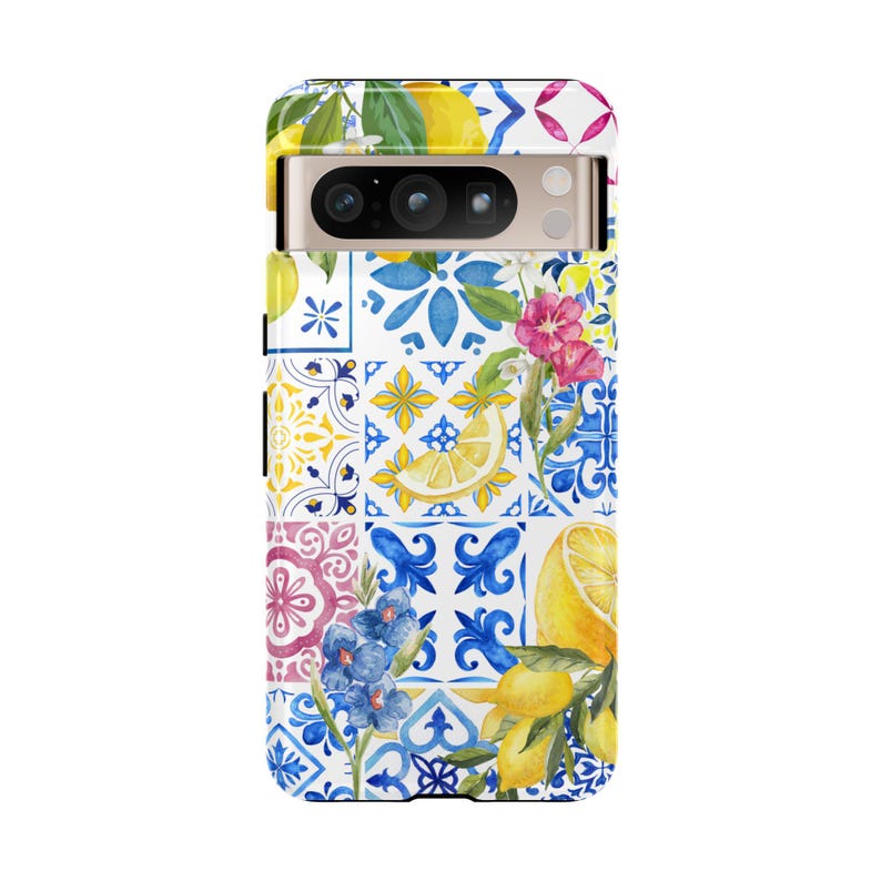 May include: A phone case with a colorful pattern of lemons, flowers, and blue and white tiles. The case has a cutout for the camera lens.