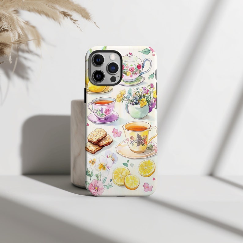 This charming watercolor design features a delightful tea time setting with floral teacups, teapots, lemons, flowers, and biscuits. The soft pastel colors and delicate details create a cozy, inviting scene perfect for any tea lover.