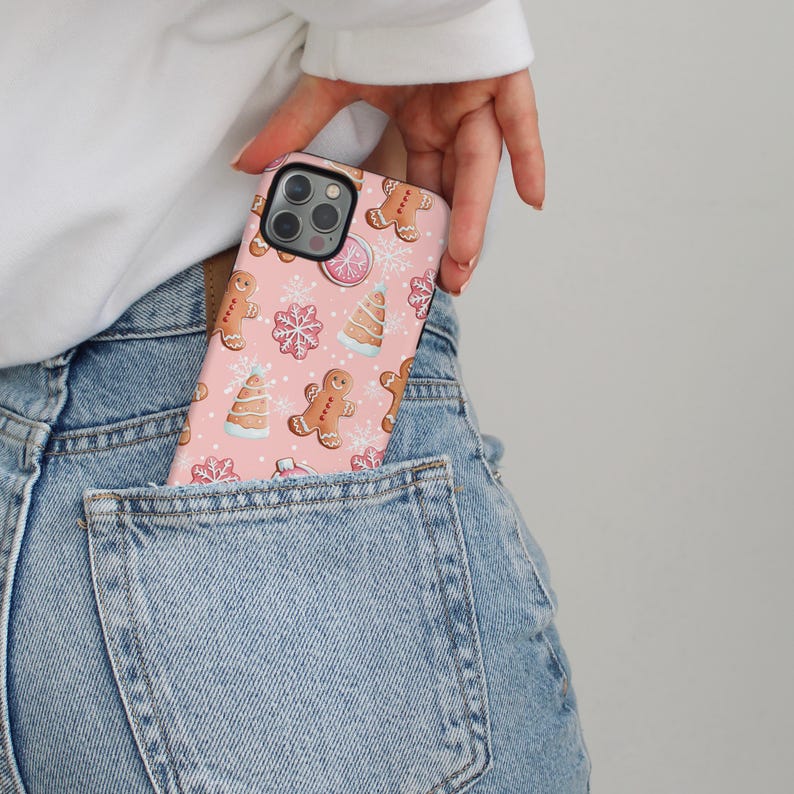 Gingerbread cookies and snowflakes pattern on a soft pink phone case.