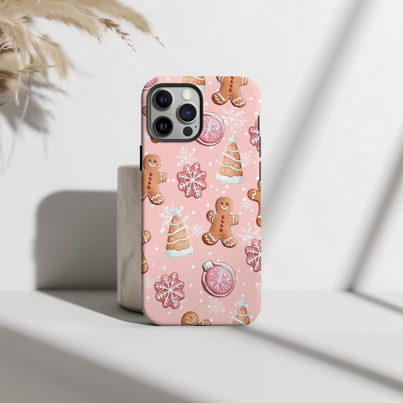Cute holiday-themed phone cover featuring snowflakes and gingerbread designs.