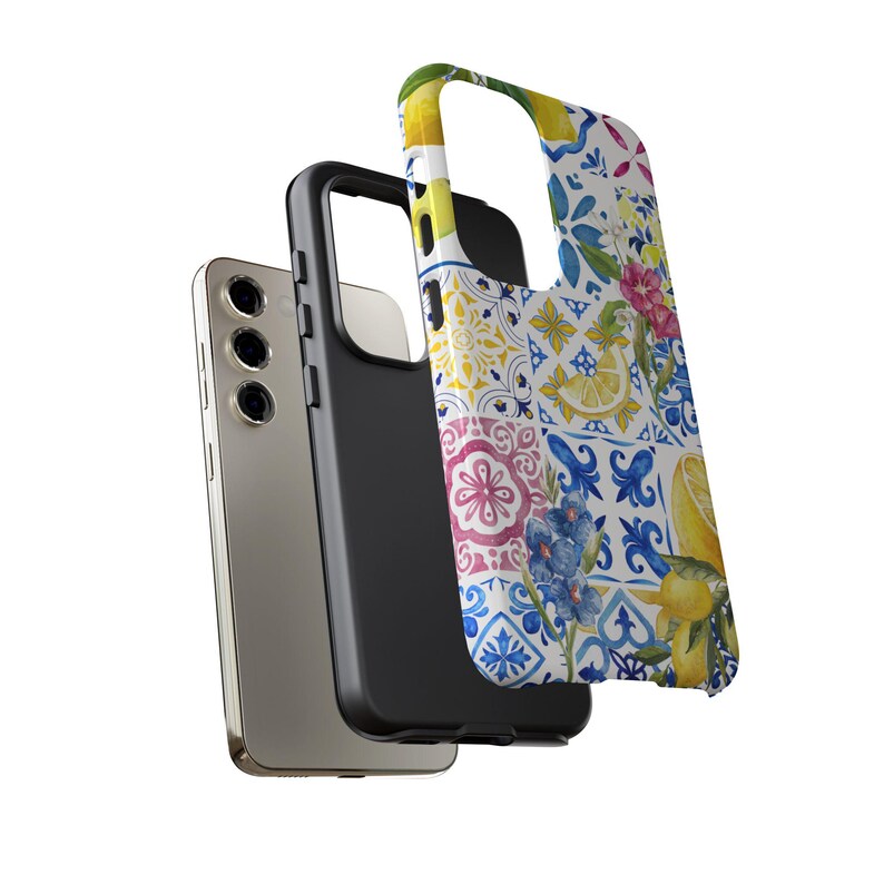 May include: A phone case with a colorful pattern of lemons, flowers, and blue and white tiles. The case is made of a hard plastic material and has a clear back.