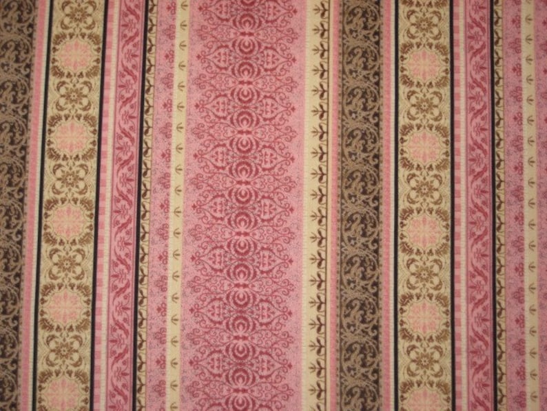 May include: A fabric featuring vertical stripes in pink, brown, and beige. The stripes display ornate floral and scroll patterns, with some stripes having solid colours and others with a black border. The design is symmetrical and detailed.