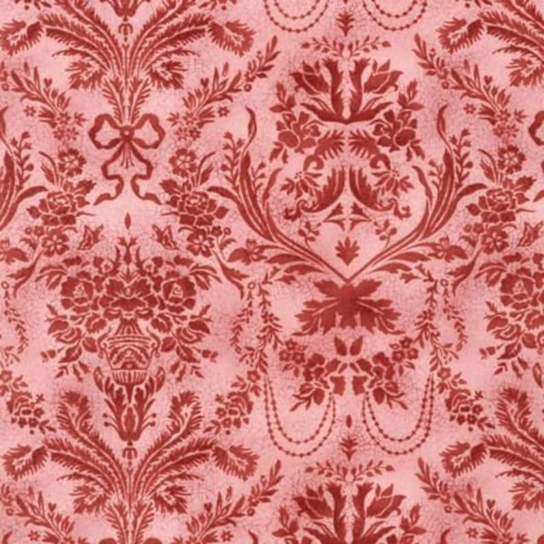 May include: A repeating floral damask pattern in red and pink. The design features stylized flowers, leaves, and ribbons, creating a vintage aesthetic. The background has a subtle, textured appearance. Ideal for fabric or wallpaper.