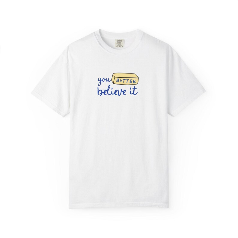 May include: White t-shirt with a blue graphic that says "you butter believe it" with a stick of butter illustration.