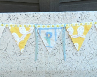 Blue, yellow, and white vintage chenille and damask decorative bunting with ribbon trim