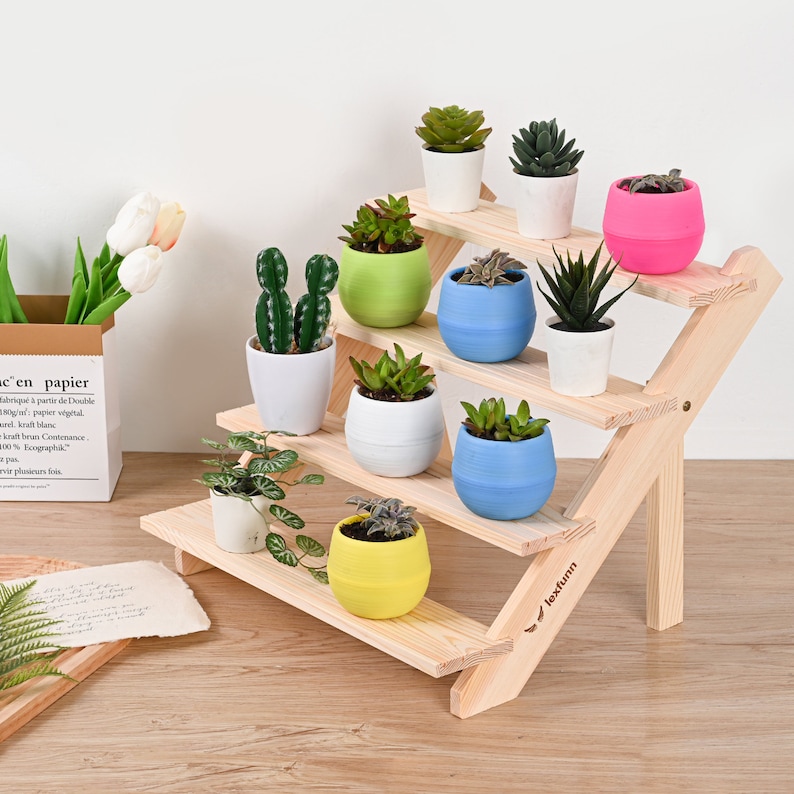 May include: A wooden plant stand with four tiers, featuring a variety of potted plants in different colors, including green, blue, yellow, and pink. The stand is made of natural wood and has a simple, rustic design. The stand is labeled "lexfunn" on the bottom right.