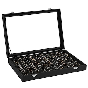 May include: Black ring display box with a glass lid. The box has 50 individual compartments for storing rings. The box is made of wood and has a velvet lining.