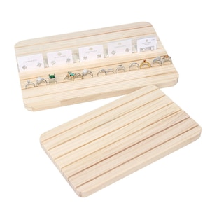 May include: A wooden ring and earring display stand with multiple slots for rings and earring cards. The stand is made of natural wood and has a light brown colour.