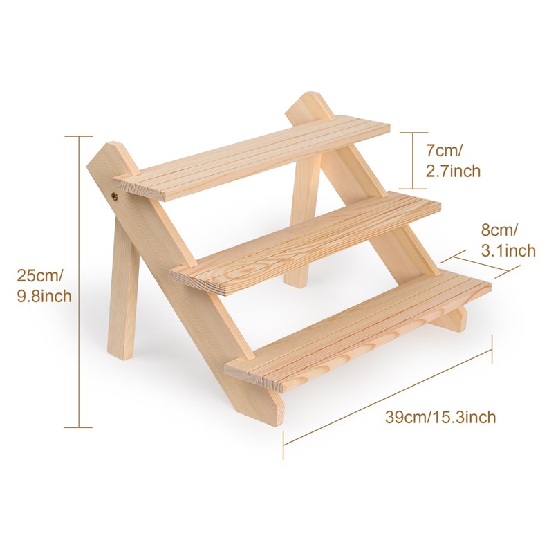 May include: A three-tier wooden shelf unit with a natural finish. The shelf is 15.3 inches wide, 9.8 inches tall, and the shelves are 2.7 inches and 3.1 inches deep.