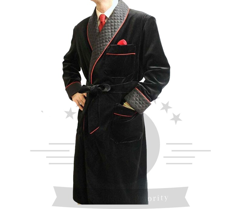 May include: A black velvet robe with red piping and a quilted collar. The robe has a sash tie and two pockets.