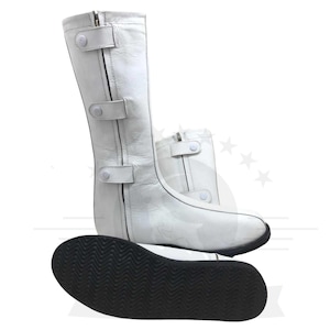 May include: White leather boots with a zipper and three white buttons on the side. The boots have a black rubber sole with a textured pattern.