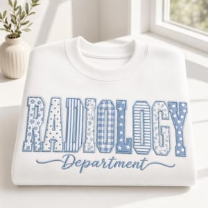 May include: A white crewneck sweatshirt featuring the word RADIOLOGY in large, block-style letters, each filled with a different blue and white pattern including stripes, stars, polka dots, and florals, with the word Department in blue script below.