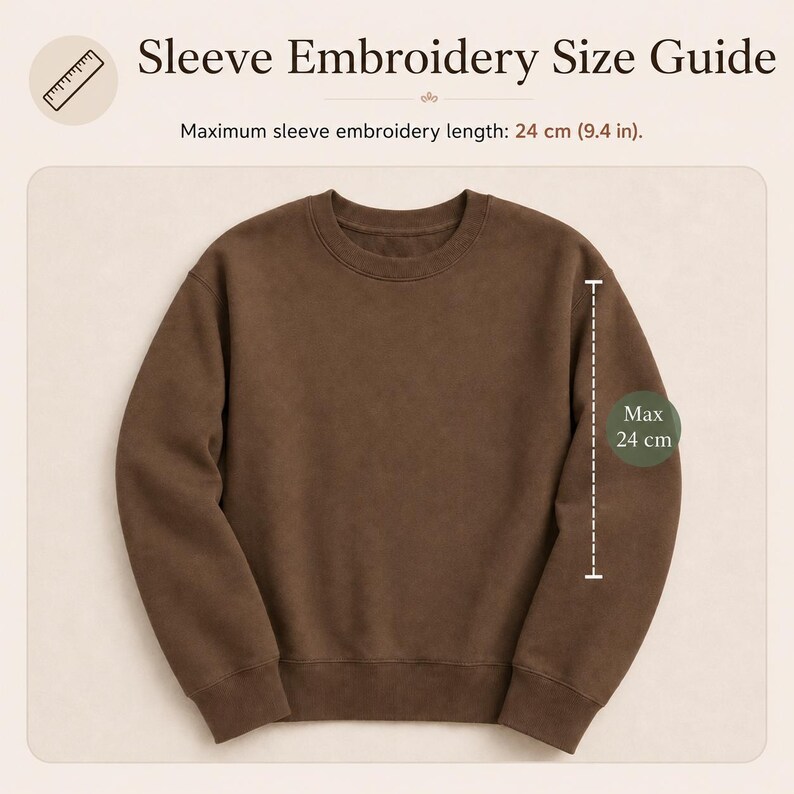 May include: A brown crewneck sweatshirt displayed with a size guide titled Sleeve Embroidery Size Guide. The graphic indicates a maximum sleeve embroidery length of 24 cm or 9.4 inches, shown with a dashed line along the sleeve of the garment.
