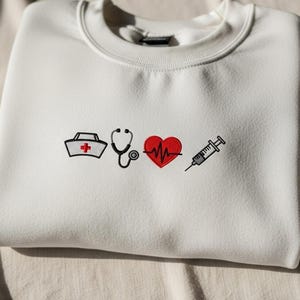 Embroidered Nurse Icons Sweatshirt, RN Fall Crewneck, Trendy Nursing Student Hoodie, Healthcare Apparel for Nurses, Appreciation Gift Tee