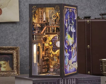 May include: A wooden miniature dollhouse with a detailed interior, featuring a staircase, furniture, and a lit window. The dollhouse is open on one side, revealing the interior, and the other side is a painted scene of a night sky with stars and a crescent moon.