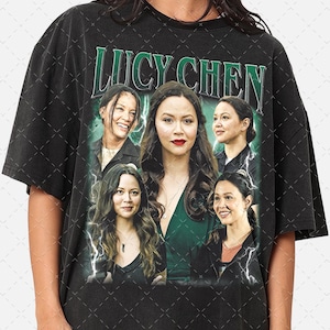 May include: Black t-shirt with a graphic print of five women. The text "Lucy Chen" is printed in white letters at the top of the graphic.