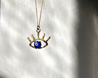 The Beholder - Eye Pendant in Gold with Blue Glass Turkish evil eye