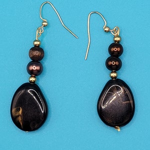 Brown polished stone dangle earrings with gold accents