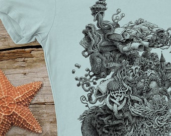 May include: A light blue t-shirt with a black and white graphic print of a complex, organic design featuring a variety of shapes and textures.