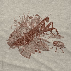 An intricate drawing of a praying mantis, snail, beetle and mushrooms, screen printed on a heather gray unisex-mens T-shirt. The drawing has a lot of intricate patterns