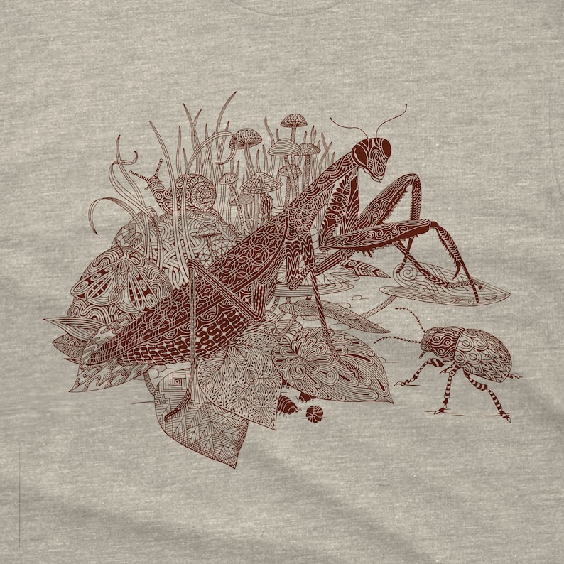 An intricate drawing of a praying mantis, snail, beetle and mushrooms, screen printed on a heather gray unisex-mens T-shirt. The drawing has a lot of intricate patterns